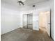 Bright bedroom with ceiling fan, mirrored closet, and nearby bathroom at 1556 Lynda Ln, Dunedin, FL 34698