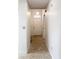 Bright hallway with tile flooring leading to the front door at 1556 Lynda Ln, Dunedin, FL 34698