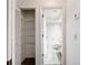 The hallway shows access to a closet with shelves and the bathroom at 1556 Lynda Ln, Dunedin, FL 34698