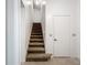 A carpeted stairway leads to the upper level of the home at 1556 Lynda Ln, Dunedin, FL 34698