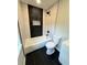 Renovated bathroom featuring a tub with black shower head, new tiling, and toilet at 1675 13Th S Ave, St Petersburg, FL 33712