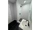 Updated bathroom showcasing a tiled shower with black fixtures, a modern vanity, and black flooring at 1675 13Th S Ave, St Petersburg, FL 33712