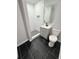 Updated bathroom with tiled shower stall, modern vanity, and black tile flooring at 1675 13Th S Ave, St Petersburg, FL 33712