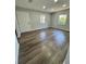 Spacious bedroom with hardwood floors, two windows, and plenty of natural light at 1675 13Th S Ave, St Petersburg, FL 33712