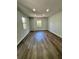 Neutral bedroom with hardwood floors and natural light shining through windows at 1675 13Th S Ave, St Petersburg, FL 33712