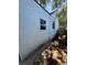 Exterior view of the home, showcasing the siding, windows and partial backyard at 1675 13Th S Ave, St Petersburg, FL 33712