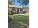Inviting single-story home featuring a covered front porch and mature trees at 1675 13Th S Ave, St Petersburg, FL 33712