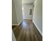 Hallway featuring wood-look flooring, neutral walls, and white baseboards at 1675 13Th S Ave, St Petersburg, FL 33712
