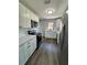 Modern kitchen featuring white cabinets, stainless steel appliances, and quartz countertops at 1675 13Th S Ave, St Petersburg, FL 33712
