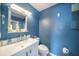 Bathroom with blue walls, a pedestal sink and a view through a window to the outside at 1813 Nova Dr, Valrico, FL 33596
