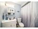 Well-maintained bathroom with a vanity sink, mirror, and shower with a curtain, providing essential amenities at 1813 Nova Dr, Valrico, FL 33596