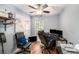 Cozy bedroom featuring hardwood floors, a ceiling fan, and natural light from the large window at 1813 Nova Dr, Valrico, FL 33596