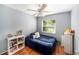 Serene bedroom featuring soft lighting, hardwood floors and comfortable furnishings at 1813 Nova Dr, Valrico, FL 33596