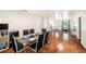 Bright dining room with hardwood floors, a modern table, and a view of the front door at 1813 Nova Dr, Valrico, FL 33596