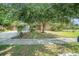 Charming single-story home with mature trees and a well-maintained lawn, front entry and long driveway at 1813 Nova Dr, Valrico, FL 33596