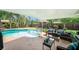Relaxing outdoor patio featuring a refreshing pool, comfortable seating, and a peaceful backyard at 1813 Nova Dr, Valrico, FL 33596