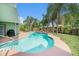 Gorgeous pool area with a refreshing pool, spacious patio, and lush landscaping, perfect for outdoor relaxation at 1813 Nova Dr, Valrico, FL 33596