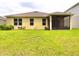 Spacious backyard featuring a screened lanai, lush green grass, and ample space for outdoor enjoyment at 18292 Hunters Meadow Walk, Land O Lakes, FL 34638