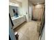 Well-lit bathroom featuring double sinks, tile floors, and a tiled shower at 18292 Hunters Meadow Walk, Land O Lakes, FL 34638