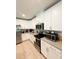Modern kitchen with granite countertops, stainless steel appliances, and bright white cabinetry at 18292 Hunters Meadow Walk, Land O Lakes, FL 34638