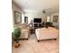 Bright living room with neutral tones, tile floors, ceiling fan, and comfortable seating at 18292 Hunters Meadow Walk, Land O Lakes, FL 34638