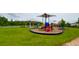 Community playground area with multiple slides and green grass at 18292 Hunters Meadow Walk, Land O Lakes, FL 34638