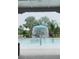 Community pool featuring splash fountain, palm trees and ample recreational space at 18292 Hunters Meadow Walk, Land O Lakes, FL 34638