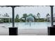 Community pool featuring a splash fountain, seating areas, and well-maintained landscaping at 18292 Hunters Meadow Walk, Land O Lakes, FL 34638