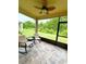 Relaxing screened lanai with comfortable seating and a ceiling fan, perfect for enjoying the outdoors at 18292 Hunters Meadow Walk, Land O Lakes, FL 34638