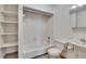Bright bathroom featuring a tub, toilet, sink and built-in shelving at 1920 E Chelsea St, Tampa, FL 33610