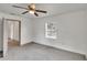 This bedroom provides neutral paint, a ceiling fan, natural light from a window, and closet access at 1920 E Chelsea St, Tampa, FL 33610