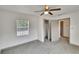 Comfortable bedroom provides neutral paint, a ceiling fan, closet access, and natural light from a window at 1920 E Chelsea St, Tampa, FL 33610