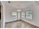 Bright dining room with hardwood floors, a chandelier and three windows at 1920 E Chelsea St, Tampa, FL 33610