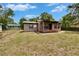 Charming single-story home featuring a metal roof, brick accents, and a cozy front porch at 1920 E Chelsea St, Tampa, FL 33610
