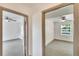 This hallway shot shows access to two bedrooms, both featuring ceiling fans and natural light at 1920 E Chelsea St, Tampa, FL 33610