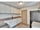 Well-lit kitchen with white cabinets, stainless steel appliances, and a door at 1920 E Chelsea St, Tampa, FL 33610