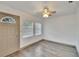 Inviting living room features wood-look flooring, a ceiling fan, and natural light from the windows at 1920 E Chelsea St, Tampa, FL 33610