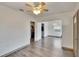 This living room provides sleek wood-look flooring, an open floorplan, and neutral color palette at 1920 E Chelsea St, Tampa, FL 33610