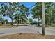 Street corner with street signs surrounded by trees, homes, and a fire hydrant at 1920 E Chelsea St, Tampa, FL 33610