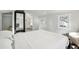 Airy bedroom with a queen bed, white linens, and a large mirror at 2015 3Rd S St, St Petersburg, FL 33705