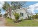 Well-maintained home with a tidy lawn, complemented by palm trees and surrounding greenery at 2015 3Rd S St, St Petersburg, FL 33705