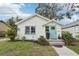 Charming home with a white exterior, light blue door, and well-maintained landscaping at 2015 3Rd S St, St Petersburg, FL 33705