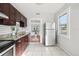 Bright kitchen with stainless steel refrigerator, and white tile flooring at 2015 3Rd S St, St Petersburg, FL 33705