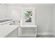 Bright kitchenette with a window seat, white cabinets, and tiled floors at 2015 3Rd S St, St Petersburg, FL 33705