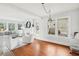 Spacious living room with hardwood floors, a brick fireplace, and ample natural light from large windows at 2015 3Rd S St, St Petersburg, FL 33705