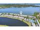Waterfront condo community featuring a serene lake, lush greenery, and recreational amenities at 219 Pompano Se Dr # C, St Petersburg, FL 33705
