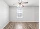 Bright bedroom features hardwood floors, a neutral color palette, and a ceiling fan at 219 Pompano Se Dr # C, St Petersburg, FL 33705