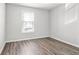 Bright bedroom features hardwood floors, a neutral color palette, and a window offering natural light at 219 Pompano Se Dr # C, St Petersburg, FL 33705