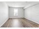 Bright bedroom with wood-look floors and a large window, creating a cozy atmosphere at 219 Pompano Se Dr # C, St Petersburg, FL 33705