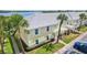 Charming yellow condo with well-manicured lawn, mature palm trees, and convenient parking at 219 Pompano Se Dr # C, St Petersburg, FL 33705